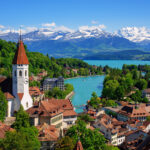 Historical Thun city and lake Thun with snow covered Bernese Highlands swiss Alps mountains in background, Canton Bern, Switzerland