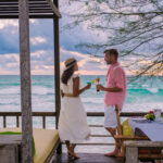 Romantic dinner on the beach in Koh Kood Thailand, a mature couple man and woman mid age Asian woman and a European man having dinner on the beach in Thailand during sunset in Ko Kut Trat