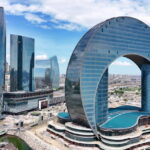 Aerial view of Azerbaijan skyscrappers, Azerbaijan Building of the Crescent Baku Hotel is in shape of a crescent, Crescent Development Project at Sunset Along Caspian Sea Coast Baku, Aerial view of Azerbaijan popular destinationsAzerbaijan, officially the Republic of Azerbaijan, is a transcontinental country located at the boundary of Eastern Europe and West Asia. It is a part of the South Caucasus region and is bounded by the Caspian Sea to the east, Russia's republic of Dagestan to the north, Georgia to the northwest, Armenia and Turkey to the west, and Iran to the south. Baku is the capital and largest city.