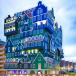 Distinctive stacked building design in Zaandam, Netherlands, during twilight.
