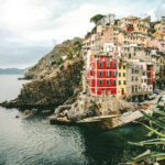 A beautiful shot of assorted-color buildings on the hill near the sea in Manarola, Italy