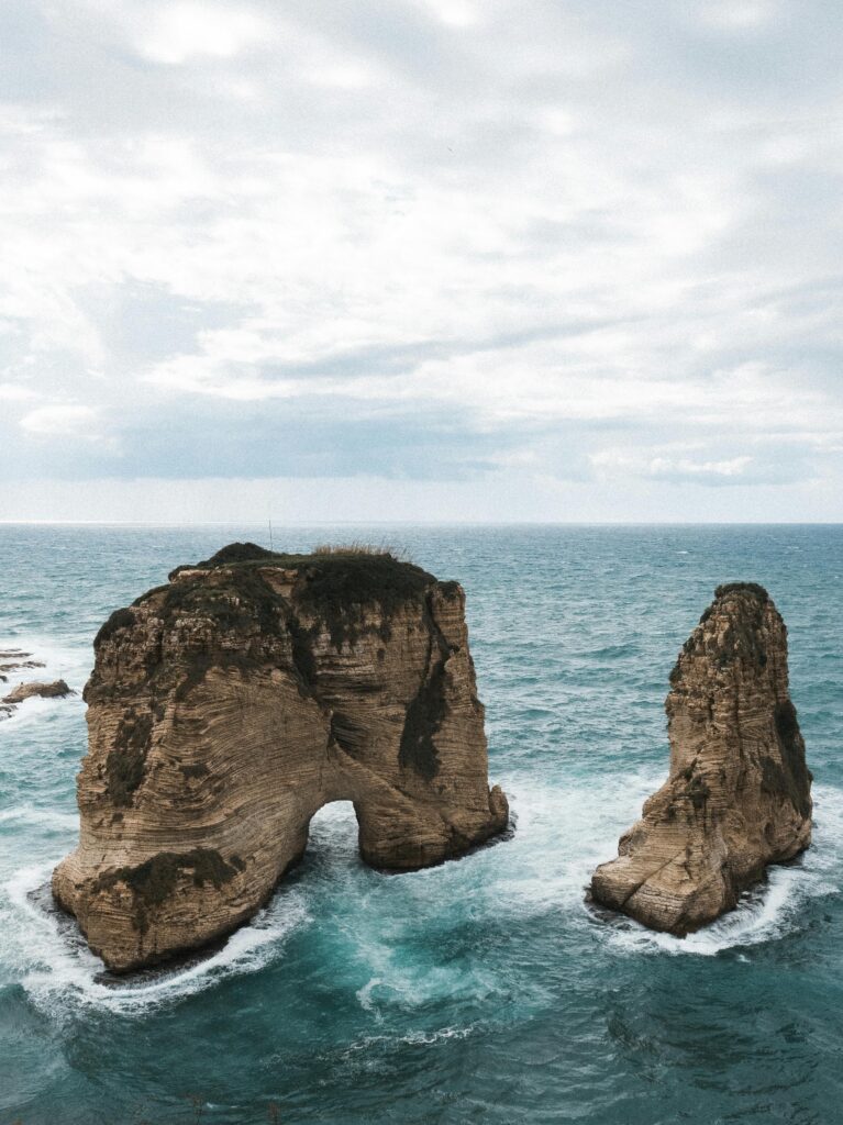 Enjoy the breathtaking Pigeon Rocks in Raouche, Beirut with dramatic waves and sky.