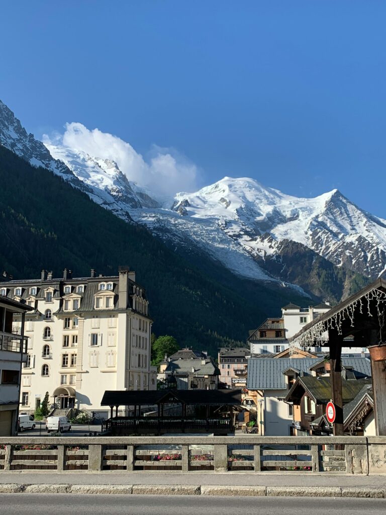 Stunning view of Chamonix-Mont-Blanc with snow-capped peaks and charming architecture in early spring.