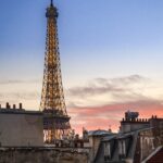 A vertical shot of the Eiffel Tower during a pink sunset in Paris, France