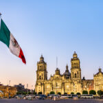 Flagpole and the Metropolitan Cathedral of the Assumption of Virgin Mary in Mexico City, the capital of Mexico