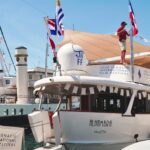 A boat docked in Cannes during a film festival, featuring decorations and flags.
