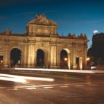 Long exposure of Puerta de Alcalá illuminated at night in Madrid, Spain.
