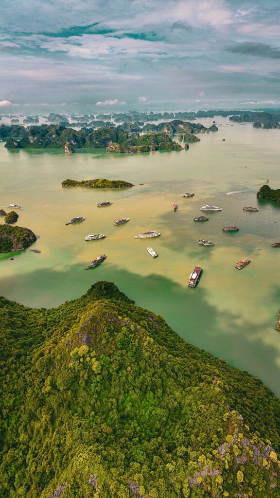 A stunning aerial view of Ha Long Bay in Vietnam with lush green islands and boats.