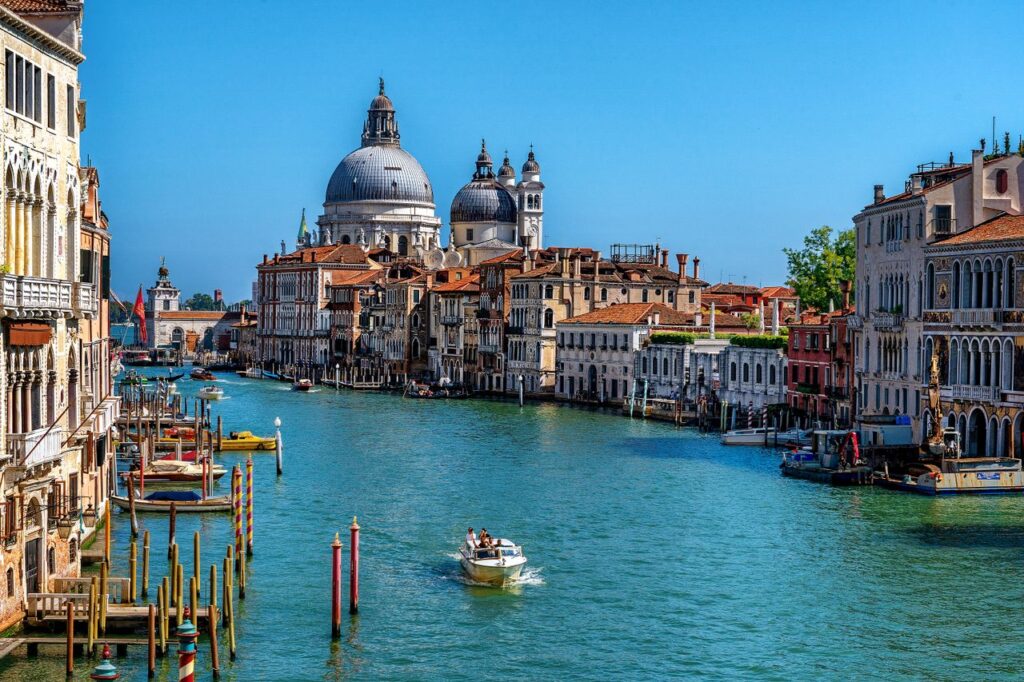 Stunning daytime view of the Grand Canal in Venice, featuring gondolas and historic architecture.
