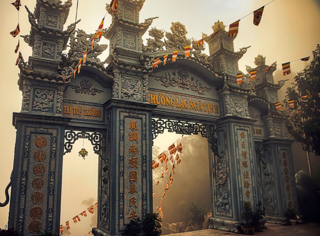 A misty scene featuring an ornate temple gateway in Vietnam, highlighting traditional architecture.