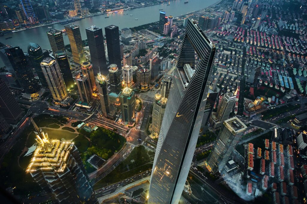 Stunning aerial view of Shanghai's illuminated skyline, featuring modern skyscrapers and vibrant cityscape at night.