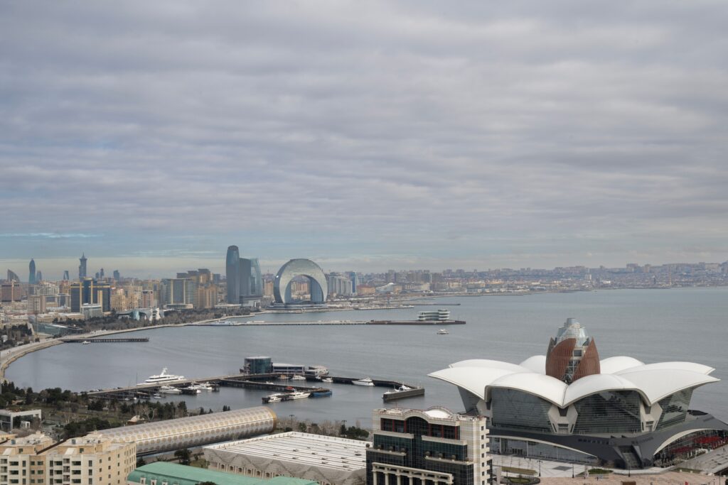 Scenic aerial view of Baku, Azerbaijan overlooking the Caspian Sea with iconic architecture and urban landscape.