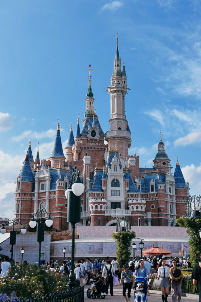 Capture the magic of Shanghai Disneyland's iconic castle with visitors enjoying a sunny day adventure.