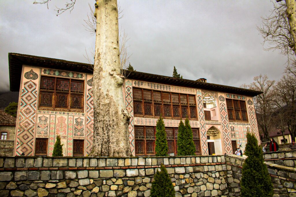 Exterior of the historical Sheki Khan's Palace in Azerbaijan, showcasing intricate facade designs.